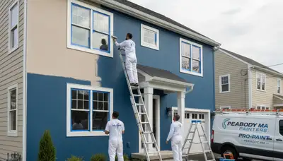 Professional house painters in Beverly MA applying exterior paint to a coastal home